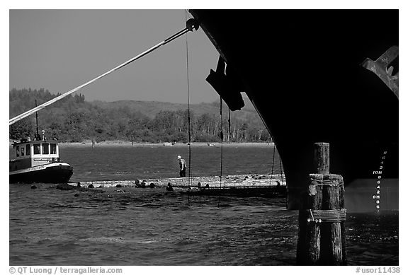 Timber, tugboat, and cargo boat bow. Oregon, USA (black and white)