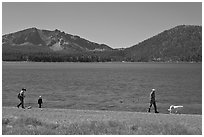Family strolling on shore of East Lake. Newberry Volcanic National Monument, Oregon, USA ( black and white)