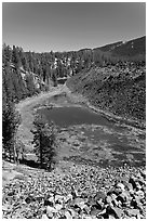 Pond at the edge of big obsidian flow. Newberry Volcanic National Monument, Oregon, USA ( black and white)