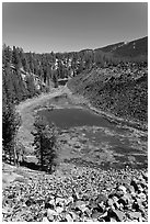 Pond at the edge of big obsidian flow. Newberry Volcanic National Monument, Oregon, USA (black and white)