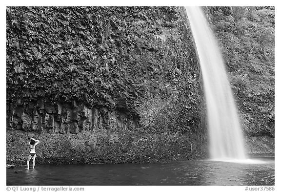 Woman in bikini at the base of Horsetail Falls. Columbia River Gorge, Oregon, USA