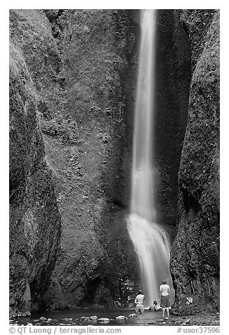 Men soaking at the base of Oneonta Falls. Columbia River Gorge, Oregon, USA (black and white)