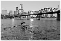 Men on double-oar shell rowing on Williamette River. Portland, Oregon, USA (black and white)