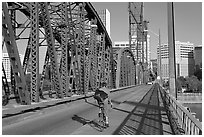 Bicyclist on Hawthorne Bridge. Portland, Oregon, USA (black and white)
