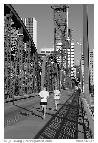 Men jogging on Hawthorne Bridge. Portland, Oregon, USA (black and white)