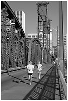 Men jogging on Hawthorne Bridge. Portland, Oregon, USA (black and white)