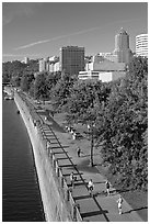 People exercising at park on Williamette River waterfront, skyline. Portland, Oregon, USA (black and white)