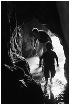 Boy and man exploring sea cave. Bandon, Oregon, USA ( black and white)