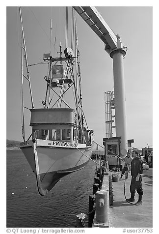 Fishing boat hoisted from water, Port Orford. Oregon, USA (black and white)