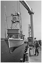 Fishing boat hoisted from water, Port Orford. Oregon, USA (black and white)
