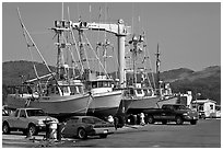 Fishing boats and cars parked on deck, Port Orford. Oregon, USA (black and white)