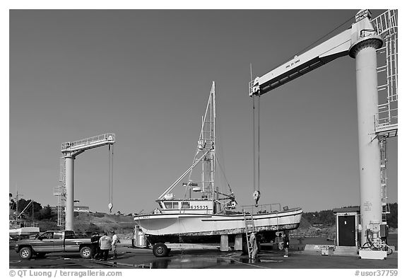 Hoists and fishing boats, Port Orford. Oregon, USA (black and white)