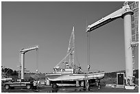 Hoists and fishing boats, Port Orford. Oregon, USA (black and white)