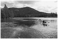 Parents towing children in kayak, Devils Lake. Oregon, USA (black and white)