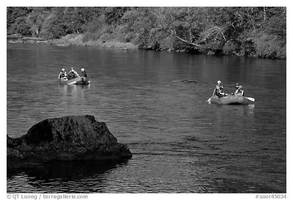 Two Rafts passing boulder, McKenzie river. Oregon, USA (black and white)