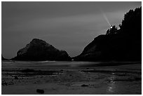 Heceta Head and lighthouse beam from beach by night. Oregon, USA ( black and white)