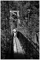 Woman hiking on suspension bridge, Lava Canyon. Mount St Helens National Volcanic Monument, Washington ( black and white)