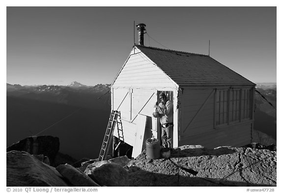 Man standing in doorway of Hidden Lake lookout. Washington