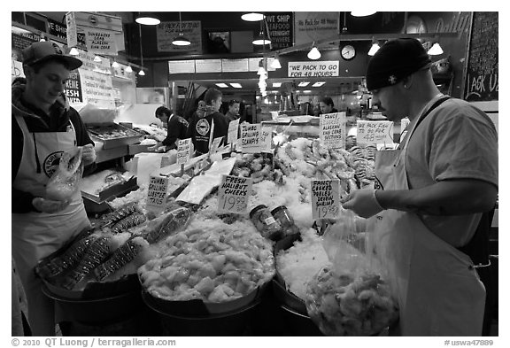 Countermen unloading seafood,  Pike Place Market. Seattle, Washington (black and white)