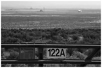 Fence and distant nuclear reactors, Hanford Reach. Washington ( black and white)