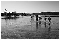 Tourists walking back from Indian Island, San Juan Islands National Monument, Orcas Island. Washington ( black and white)