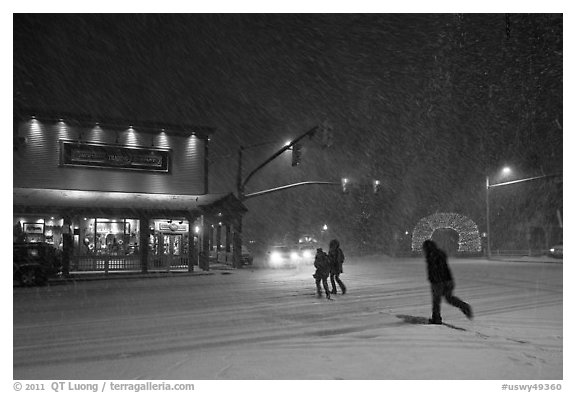 People cross street in night blizzard. Jackson, Wyoming, USA
