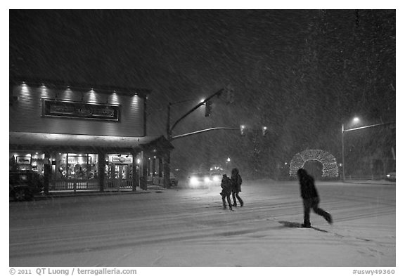 People cross street in night blizzard. Jackson, Wyoming, USA (black and white)