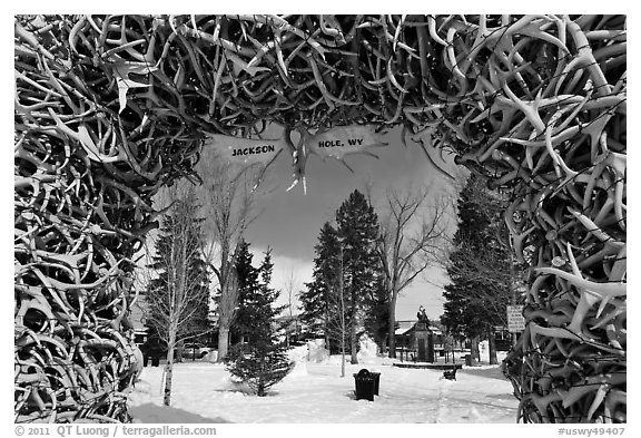 Town Square framed by Antler Arch in winter. Jackson, Wyoming, USA