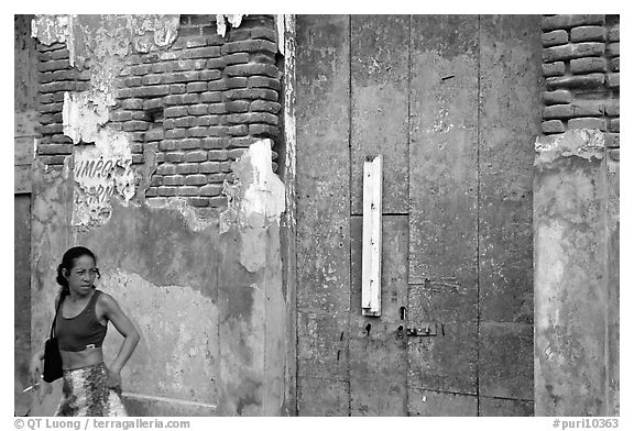 Woman in front of a decaying brick wall, Ponce. Puerto Rico (black and white)