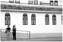 Two women standing in front of a church, La Parguera. Puerto Rico (black and white)