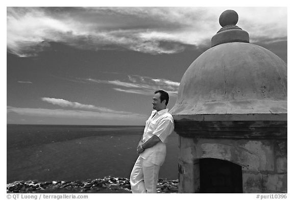 Man leaning against a lookout turret, Fort San Felipe del Morro. San Juan, Puerto Rico (black and white)