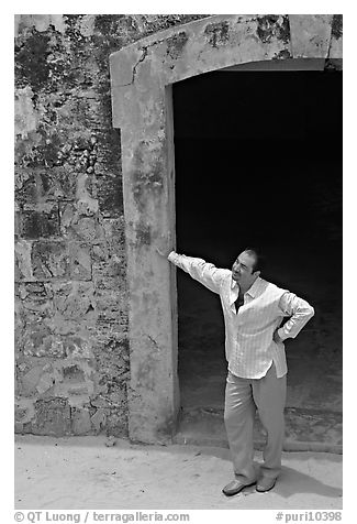 Man standing next to a doorway, El Morro Fortress. San Juan, Puerto Rico (black and white)