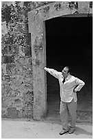 Man standing next to a doorway, El Morro Fortress. San Juan, Puerto Rico (black and white)