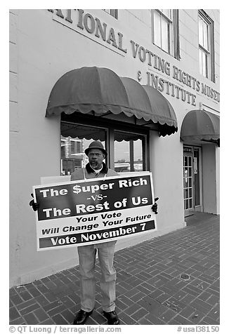 African-American man holding a voting sign in front of the voting rights museum. Selma, Alabama, USA (black and white)