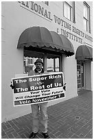 African-American man holding a voting sign in front of the voting rights museum. Selma, Alabama, USA (black and white)