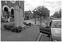 African-American man sitting in car looking at Martin Luther King memorial. Selma, Alabama, USA (black and white)