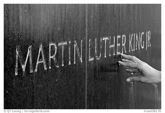 Hand touching the letters Martin Luther King on the Civil Rights Memorial wall. Montgomery, Alabama, USA (black and white)