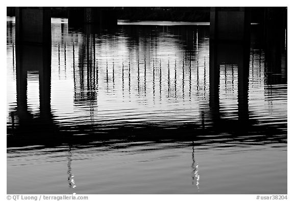 Bridges reflected in the Arkansas River at sunrise. Little Rock, Arkansas, USA (black and white)