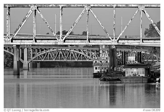 Bridges over Arkansas River, submarine and riverboats at sunrise. Little Rock, Arkansas, USA (black and white)