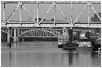 Bridges over Arkansas River, submarine and riverboats at sunrise. Little Rock, Arkansas, USA (black and white)