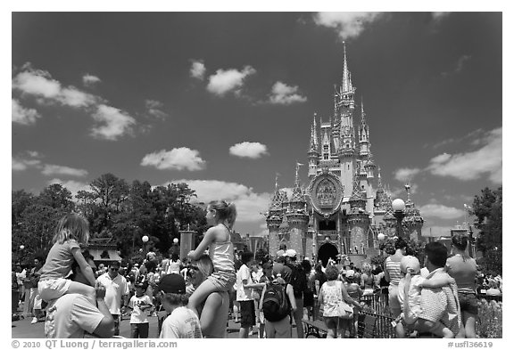 Girls on fathers shoulders, Cinderella Castle. Orlando, Florida, USA (black and white)