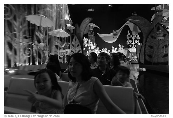 Families in indoor boat ride, Magic Kingdom. Orlando, Florida, USA (black and white)