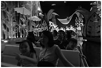 Families in indoor boat ride, Magic Kingdom. Orlando, Florida, USA (black and white)