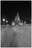 Blurred crowds and Cinderella Castle at night. Orlando, Florida, USA (black and white)