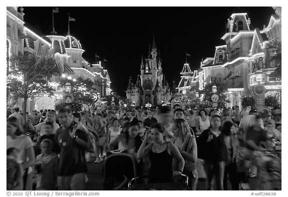 Main Street at night with crowds and castle. Orlando, Florida, USA (black and white)