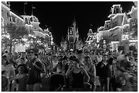 Main Street at night with crowds and castle. Orlando, Florida, USA (black and white)