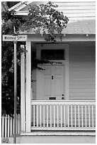 Pastel-colored house, tropical flowers, street sign. Key West, Florida, USA ( black and white)