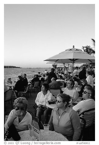 Crowds celebrating sunset at Mallory Square. Key West, Florida, USA (black and white)