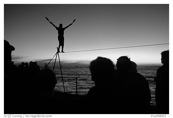 Equilibrist on Mallory Square at sunset. Key West, Florida, USA (black and white)