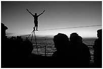 Equilibrist on Mallory Square at sunset. Key West, Florida, USA ( black and white)